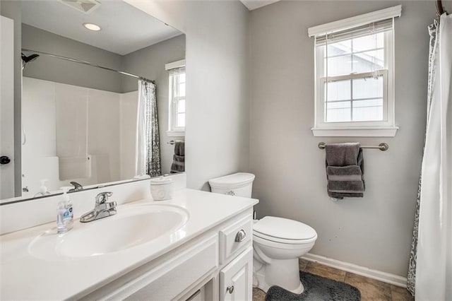 3204 SW Alice Ln, Lees Summit, MO 64082 - full bath with vanity, toilet, a shower with shower curtain, baseboards, and visible vents