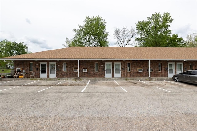 ranch-style house featuring brick siding and uncovered parking