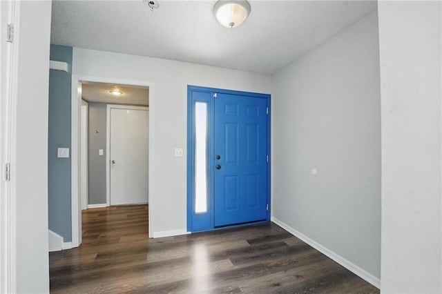 entrance foyer featuring wood finished floors and baseboards