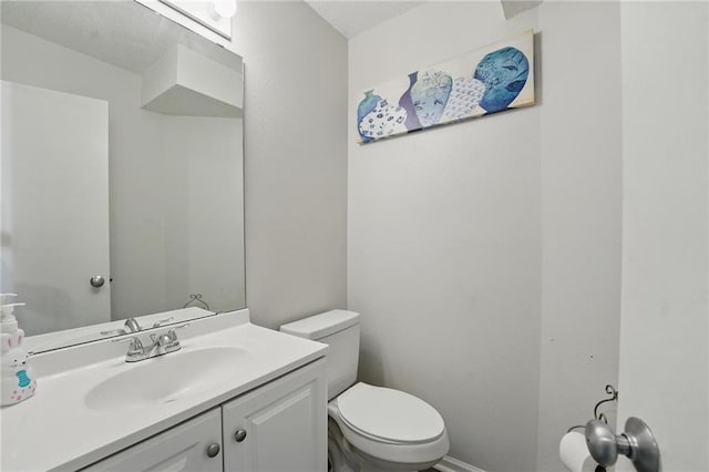bathroom featuring toilet and vanity