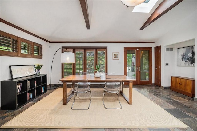 dining area with french doors, vaulted ceiling with skylight, baseboards, and visible vents