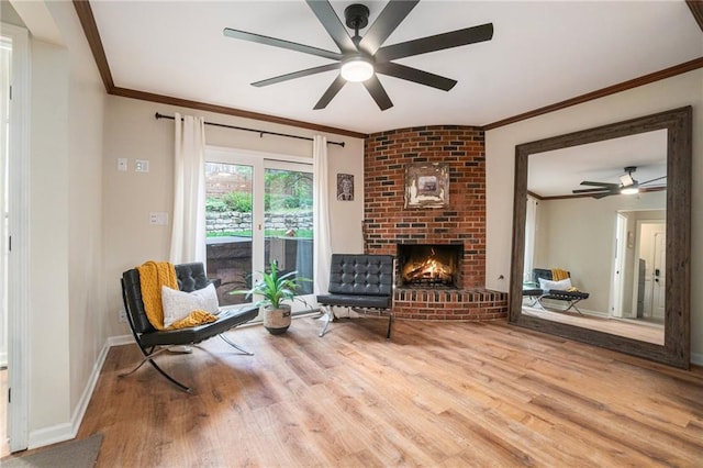 sitting room with ornamental molding, ceiling fan, and wood finished floors