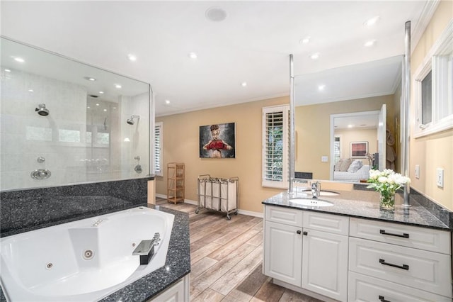 ensuite bathroom with crown molding, vanity, wood finished floors, ensuite bathroom, and a tile shower