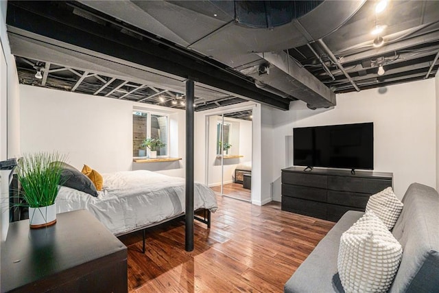 bedroom featuring baseboards and wood finished floors