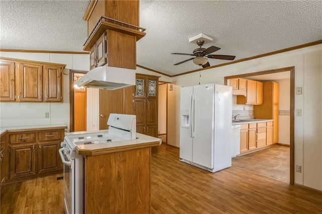 20 SE E Hwy, Trenton, MO 64683 - kitchen featuring under cabinet range hood, a ceiling fan, ornamental molding, white appliances, and a textured ceiling