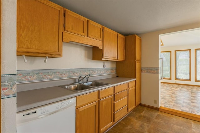 20 SE E Hwy, Trenton, MO 64683 - kitchen with light countertops, dishwasher, a sink, baseboards, and brown cabinetry