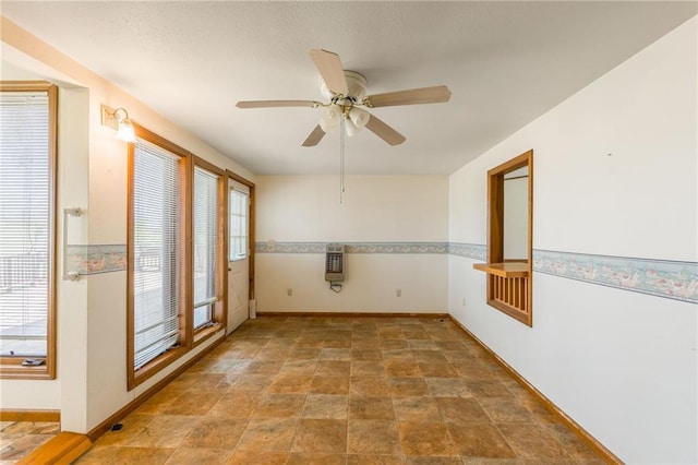 20 SE E Hwy, Trenton, MO 64683 - empty room with a wealth of natural light, a ceiling fan, heating unit, and baseboards