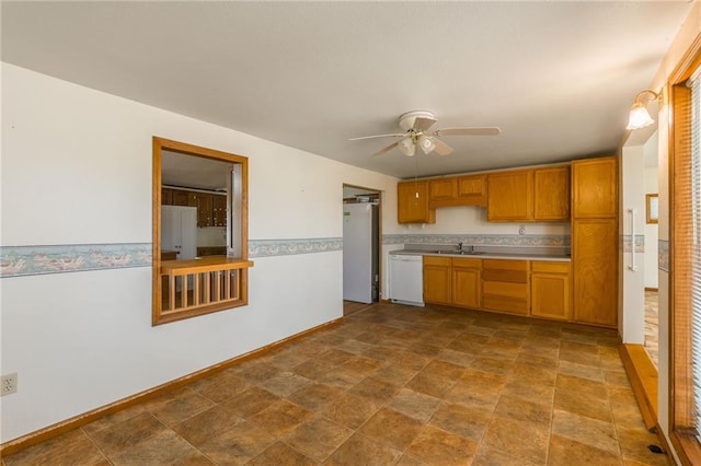 20 SE E Hwy, Trenton, MO 64683 - kitchen featuring a sink, a ceiling fan, white appliances, stone finish flooring, and light countertops