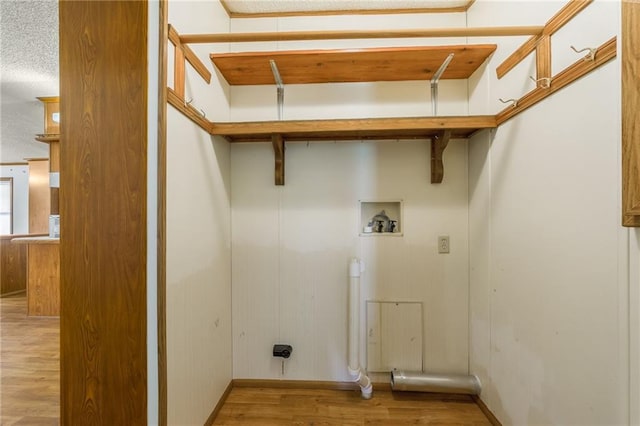 20 SE E Hwy, Trenton, MO 64683 - laundry area featuring wood finished floors, hookup for a washing machine, a textured ceiling, electric dryer hookup, and laundry area