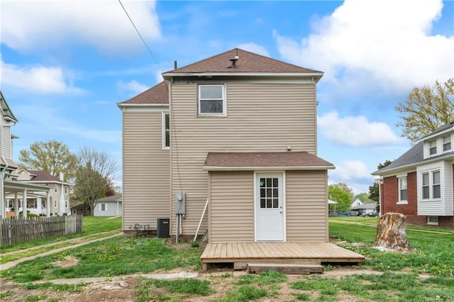 1404 Main St, Higginsville, MO 64037 - rear view of property with central AC, a wooden deck, and a shingled roof