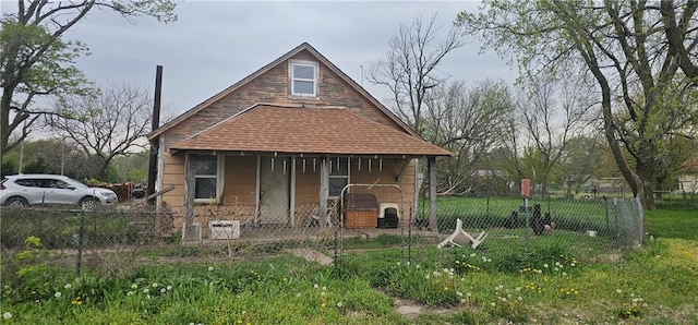 back of property featuring covered porch and fence