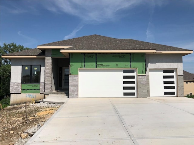 14511 S Dawson St, Olathe, KS 66061 - view of front of house with stone siding, an attached garage, driveway, and a shingled roof