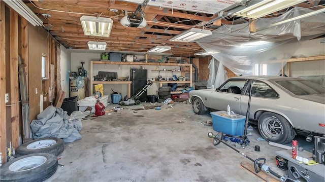 812 Pacific Ave, Osawatomie, KS 66064 - garage featuring a garage door opener and freestanding refrigerator