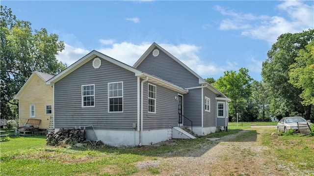 812 Pacific Ave, Osawatomie, KS 66064 - view of side of home with driveway, entry steps, and a yard