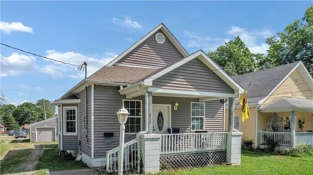 812 Pacific Ave, Osawatomie, KS 66064 - bungalow with a porch, roof with shingles, a garage, and an outdoor structure