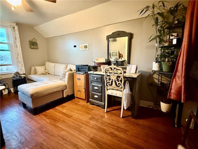 sitting room with wood finished floors, a ceiling fan, and vaulted ceiling
