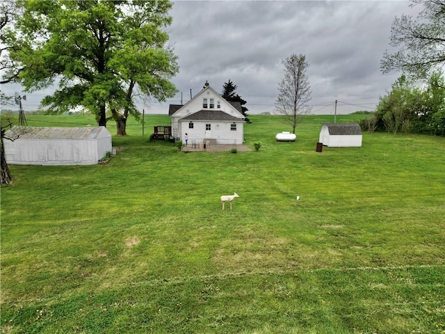 view of yard with an outdoor structure and a storage unit