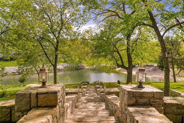 surrounding community featuring a water view