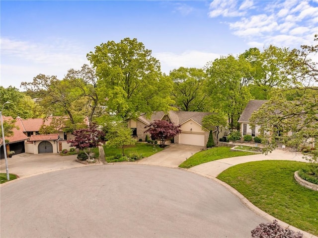 view of front of property with concrete driveway, stucco siding, and a front yard