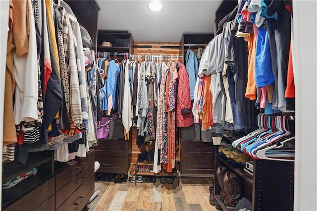 walk in closet featuring light wood-style flooring