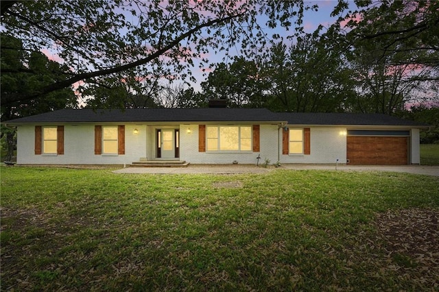 single story home featuring concrete driveway, an attached garage, a chimney, and a front yard