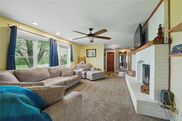 carpeted living area featuring recessed lighting, a ceiling fan, and a brick fireplace