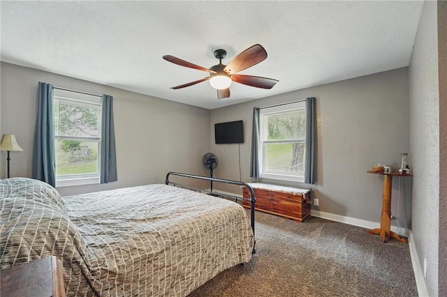 carpeted bedroom with baseboards, multiple windows, and ceiling fan