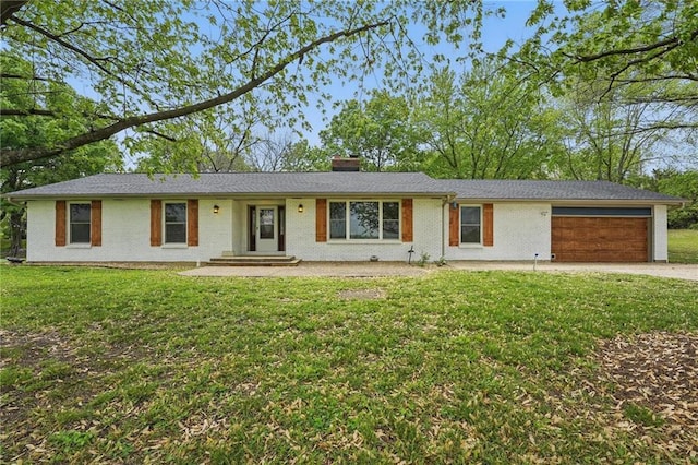 ranch-style home with an attached garage, a front lawn, driveway, and a chimney