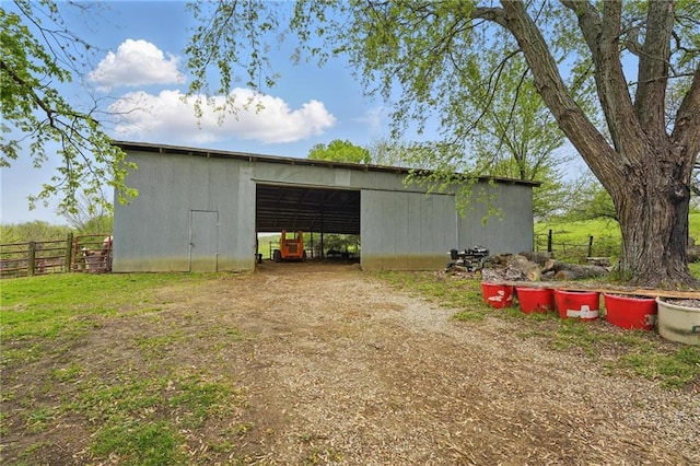 view of pole building with fence