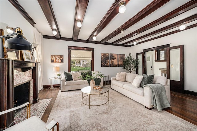 525 W 38th St, Kansas City, MO 64111 - living area with beamed ceiling, wood finished floors, baseboards, and a fireplace