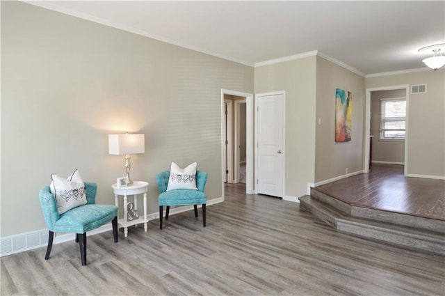 464 W 104th St Unit A, Kansas City, MO 64114 - sitting room featuring wood finished floors, visible vents, and ornamental molding