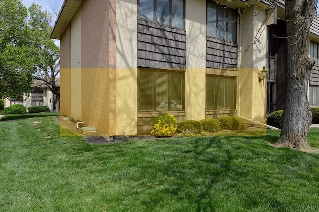 464 W 104th St Unit A, Kansas City, MO 64114 - view of home's exterior with a lawn and stucco siding