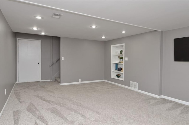 464 W 104th St Unit A, Kansas City, MO 64114 - finished below grade area featuring built in shelves, baseboards, carpet flooring, and visible vents