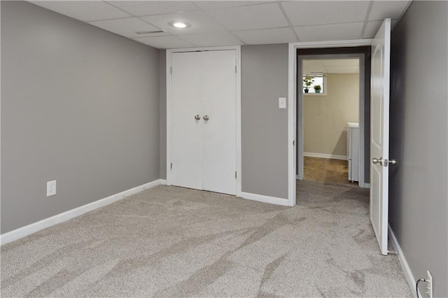 464 W 104th St Unit A, Kansas City, MO 64114 - unfurnished bedroom with a paneled ceiling, baseboards, and light carpet