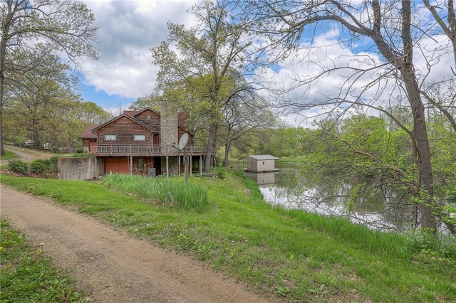 31025 203rd St, Leavenworth, KS 66048 - exterior space featuring a shed, a deck with water view, and a chimney
