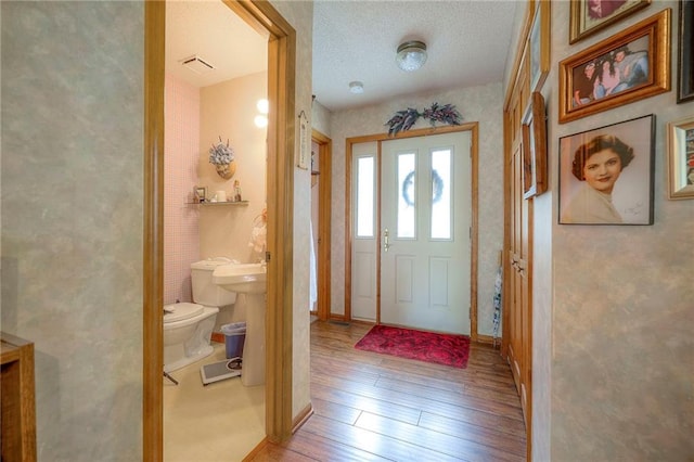 31025 203rd St, Leavenworth, KS 66048 - foyer entrance featuring visible vents, baseboards, and hardwood / wood-style flooring