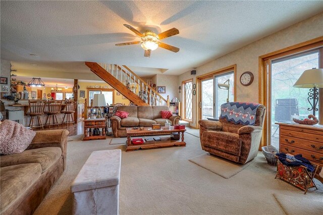 31025 203rd St, Leavenworth, KS 66048 - carpeted living room featuring a textured ceiling, a wealth of natural light, and stairway