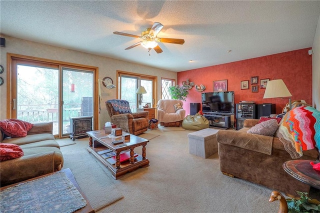 31025 203rd St, Leavenworth, KS 66048 - living area with ceiling fan, carpet, a wood stove, and a textured ceiling