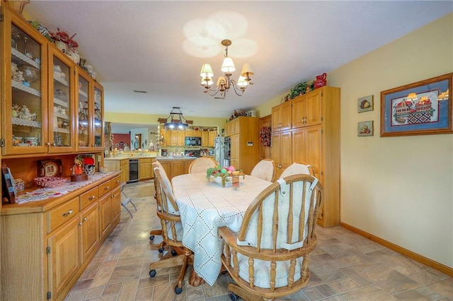 31025 203rd St, Leavenworth, KS 66048 - dining space with baseboards, stone finish flooring, and a notable chandelier