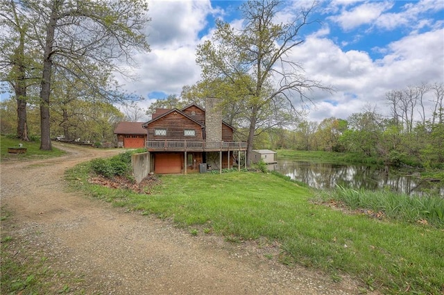 31025 203rd St, Leavenworth, KS 66048 - exterior space featuring an attached garage, driveway, and a deck with water view