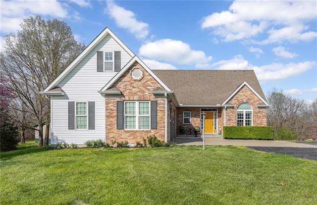 view of front facade with a front lawn and brick siding