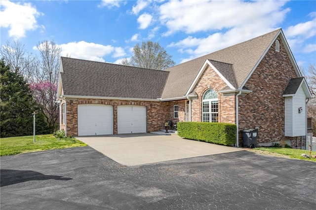 view of front of home with brick siding, aphalt driveway, roof with shingles, and a garage