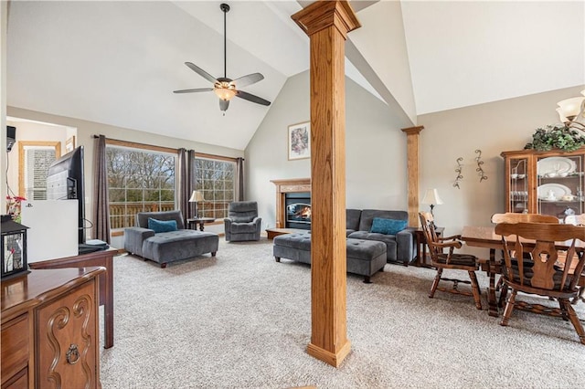 living room featuring ceiling fan, decorative columns, high vaulted ceiling, and light colored carpet