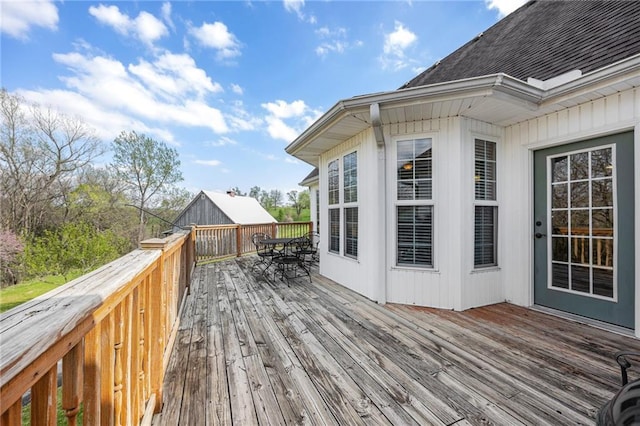 wooden terrace featuring outdoor dining space