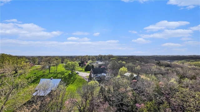 drone / aerial view with a wooded view