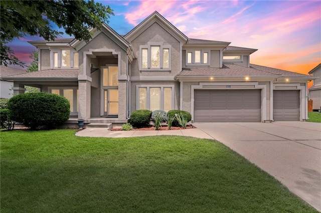 5108 W 150th St, Leawood, KS 66224 - view of front of house featuring driveway, a garage, a lawn, and stucco siding