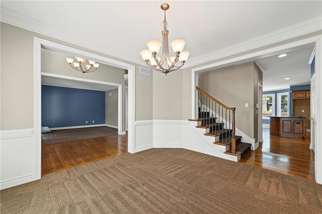 5108 W 150th St, Leawood, KS 66224 - unfurnished dining area with a chandelier, stairway, ornamental molding, carpet floors, and wood finished floors