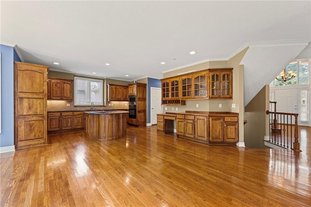 5108 W 150th St, Leawood, KS 66224 - kitchen featuring brown cabinetry, dark wood-style flooring, ornamental molding, glass insert cabinets, and a center island