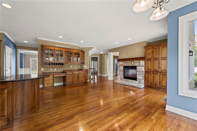 5108 W 150th St, Leawood, KS 66224 - kitchen with brown cabinets, dark wood finished floors, recessed lighting, glass insert cabinets, and ornamental molding
