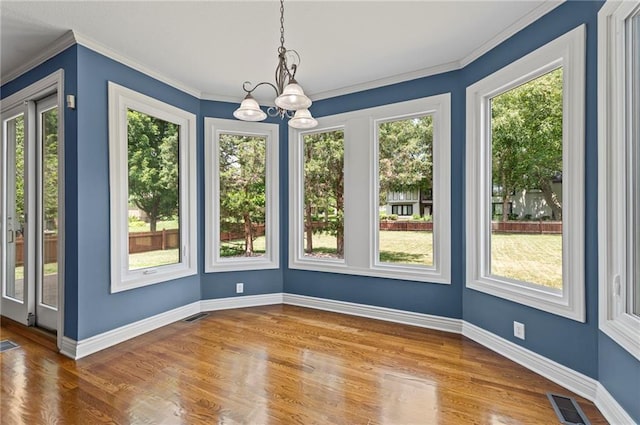 5108 W 150th St, Leawood, KS 66224 - unfurnished dining area with plenty of natural light, a chandelier, wood finished floors, and ornamental molding
